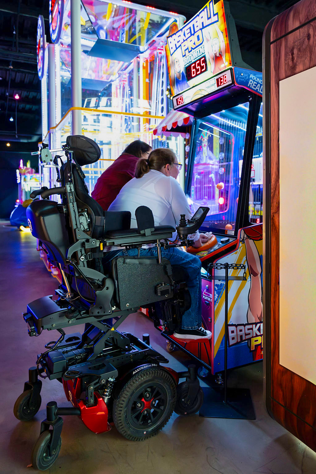 Amylior ALLTRACK M3 wheelchair used in an accessible arcade while playing a basketball game